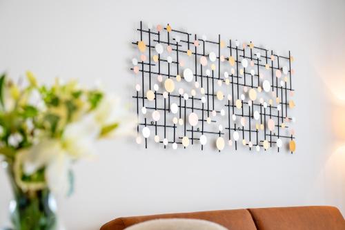 a chandelier hanging on a wall with a table at Apartment SarAna Trogir in Trogir