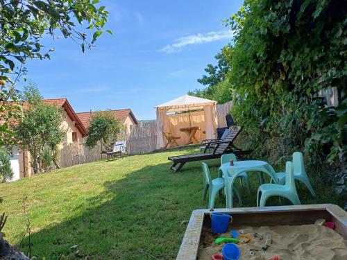 a backyard with a sandbox and a table and chairs at Cazare La Luiza b in Şura Mare