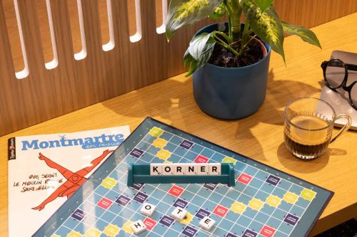 a board game on a table next to a book at Korner Montmartre in Paris