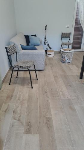 a living room with a couch and a wooden floor at Casacocco' - Agri Host in San Ginesio
