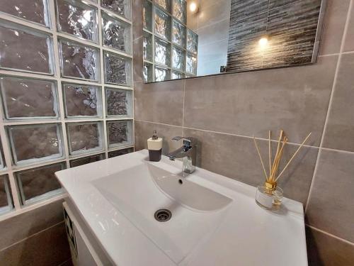 a bathroom with a white sink and a mirror at Sea View 2-beds 'Estrela' Apartment - Praia da Luz in Luz