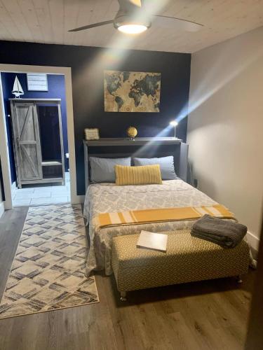 a bedroom with a large bed and a rug at Legacy Barn on Sugar Creek in Bentonville