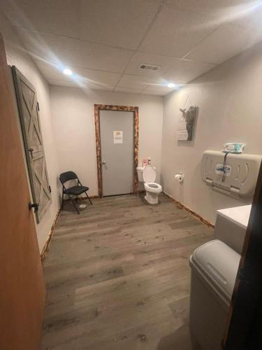 a bathroom with a toilet and a sink at Legacy Barn on Sugar Creek in Bentonville