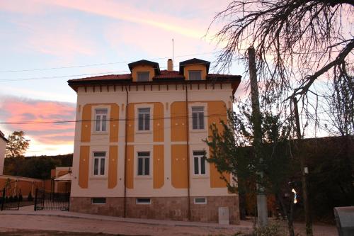 an orange and white building with a roof at Villa Paris in Hisarya