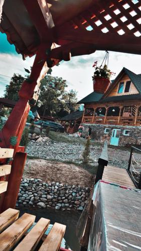 a view of a house from a wooden bridge at Pensiunea Teodora Breb Maramu in Breb