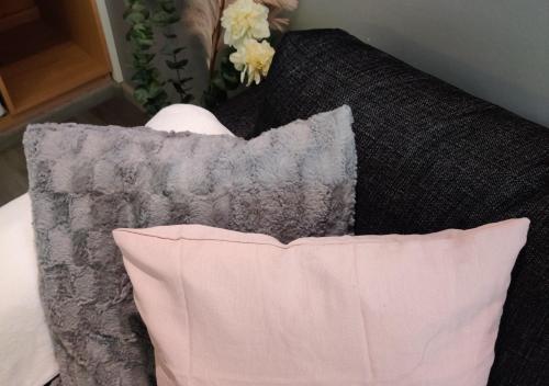 a pillow sitting on top of a couch at Viihtyisä yksiö Porissa in Pori
