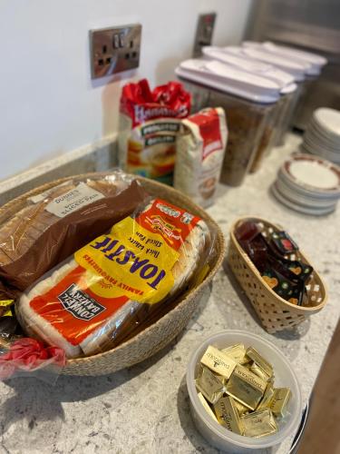 a counter top with some food and some bowls of food at Heyday Hostel Ballina in Ballina