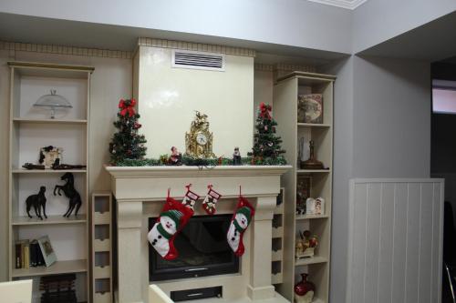 a living room with a fireplace with christmas decorations at Villa Paris in Hisarya