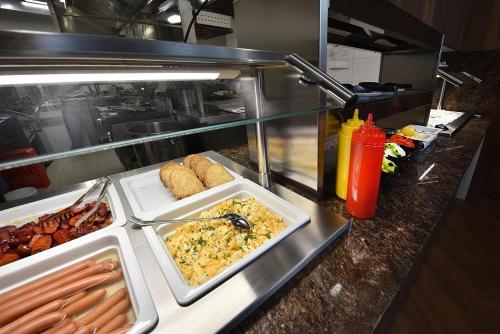 a buffet line with many different dishes of food at Hotel Ovruč - rodinný apartmán 111 in Štrbské Pleso