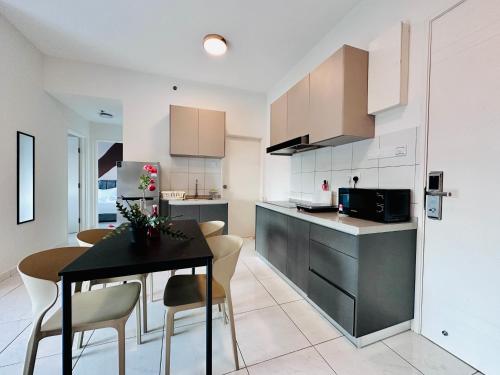 a kitchen and dining room with a table and chairs at The Sun 1 or 3BR Bayan Lepas 4 to 10 pax WL in Bayan Lepas
