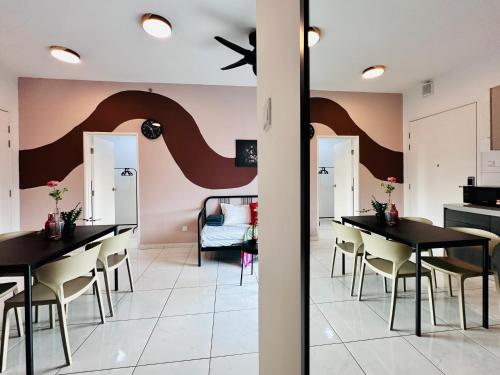 a dining room with black tables and chairs and pink walls at The Sun 1 or 3BR Bayan Lepas 4 to 10 pax WL in Bayan Lepas