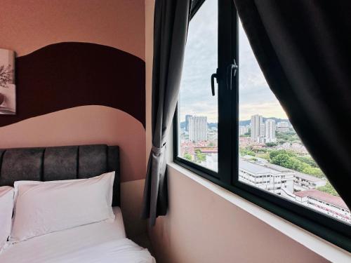 a bed in a room with a window at The Sun 1 or 3BR Bayan Lepas 4 to 10 pax WL in Bayan Lepas