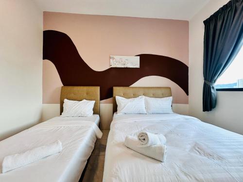 two beds sitting next to each other in a bedroom at The Sun 1 or 3BR Bayan Lepas 4 to 10 pax WL in Bayan Lepas