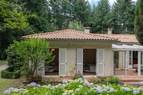 a small house with a garden in front of it at Magnifique Maison Paisible avec Piscine in Jaujac
