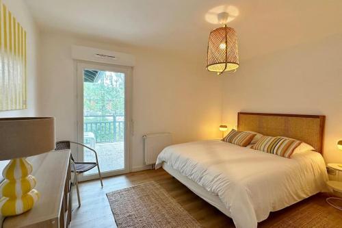 une chambre avec un lit et une grande fenêtre dans l'établissement Spacieux et confortable appartement T3 de 73 m2, à Soorts-Hossegor