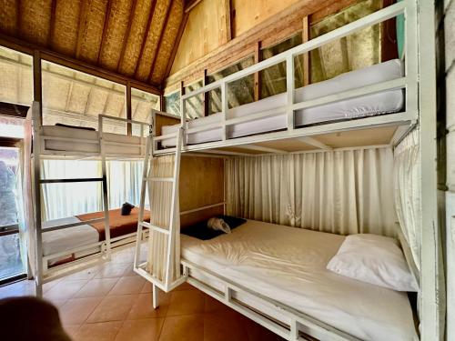 a bedroom with two bunk beds in a room at Bali Telaga Hati Yoga Healing And Retreat Center Hostel in Sanur