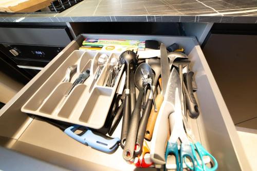a drawer filled with utensils in a kitchen at Le Charmant d'Ecully Logement Unique Avec Jardin à 10 minutes de Lyon in Écully