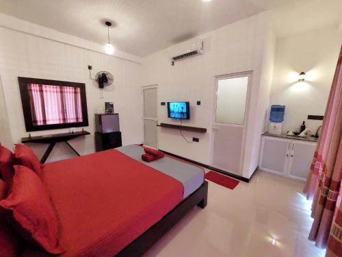 a bedroom with a bed and a television in it at CHEN VILLA - Near Airport in Negombo