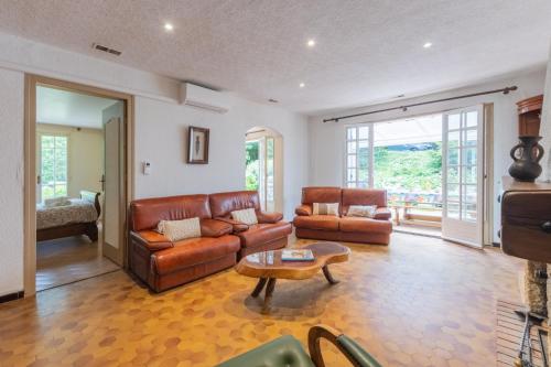 a living room with a couch and a table at Magnifique Maison Paisible avec Piscine in Jaujac