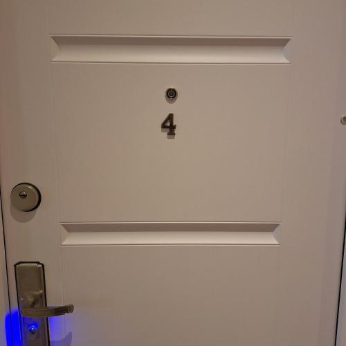 a door with the number four on it at ALRO Stúdió Apartmanház in Balatonszárszó