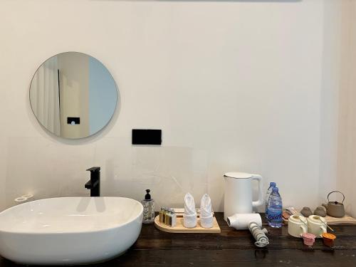 a bathroom with a white sink and a mirror at CANG 藏In山院 in Yangshuo