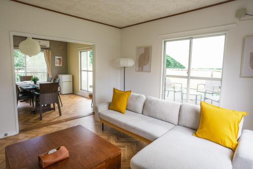 a living room with a couch and a table at Vamo House in Kumamoto