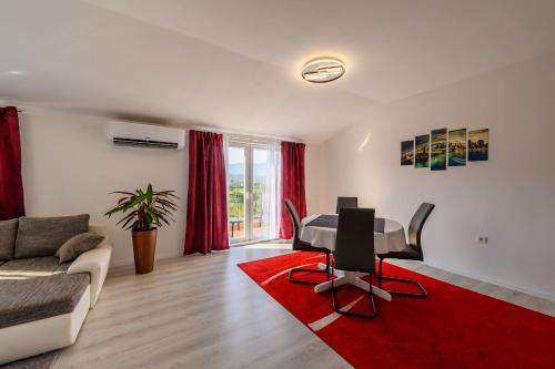 a living room with a table and a couch at Apartman Dora Metković in Metković