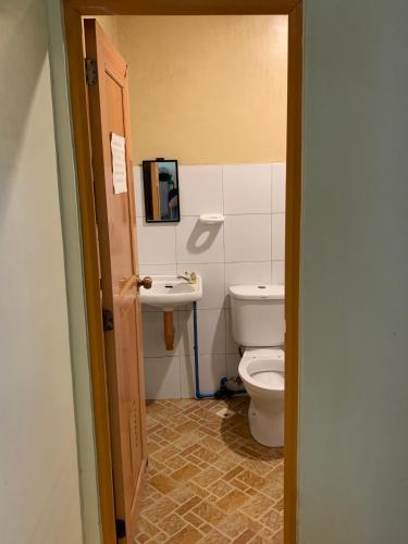 a bathroom with a toilet and a sink at Four Twenty Hostel in General Luna