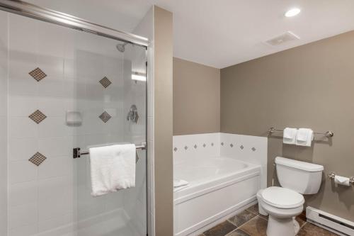a white bathroom with a toilet and a shower at Horstman House by Whistler Premier in Whistler
