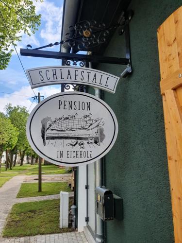 a sign for a restaurant on the side of a building at Schlafstall Eichholz in Kermen