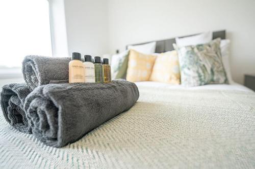 a bedroom with a bed with towels on it at High Peak 5-Star Haven Gardens, Parking & WiFi in Furness Vale