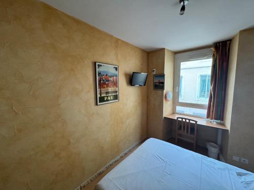 a bedroom with a bed and a window at Hôtel Bosquet Pau Centre - Self Check In Budget Hotel in Pau