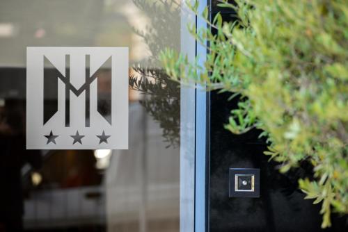 a sign on a glass door with stars on it at Hôtel & Appartements Monsigny in Nice