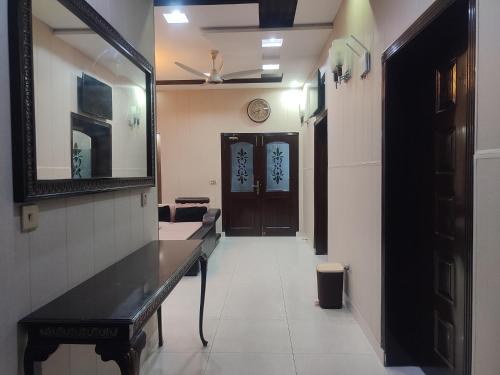 a hallway with a room with a mirror and a door at Fully Serviced Holiday Homes Near Emporium Mall & Expo Center in Lahore