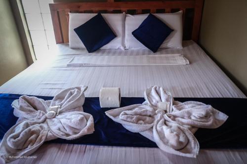 a bed with two towels on top of it at Camaya-an Paradise Beach Resort in Malabugas