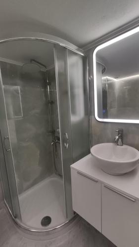 a bathroom with a shower and a sink at Blue Beach Siviri Chalkidiki in Siviri