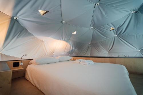 a bedroom with a large bed in a tent at Dômes Charlevoix in Petite-Rivière-Saint-François