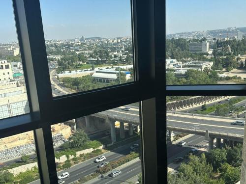 a view of a highway from an office window at Ramada Jerusalem Hotel in Jerusalem