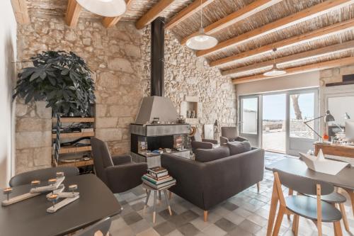 a living room with a couch and a fireplace at Mangiabove in Marina di Ragusa