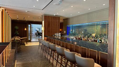 a bar in a restaurant with a row of chairs at Hyatt Centric Levent Istanbul in Istanbul