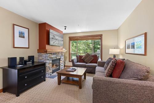 a living room with a couch and a fireplace at Horstman House by Whistler Premier in Whistler