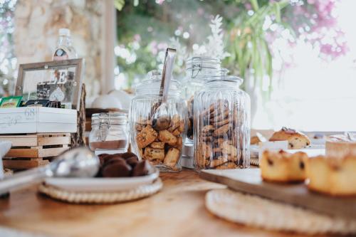 a table with jars of cookies and other snacks at Masseria Torrepietra in Monopoli