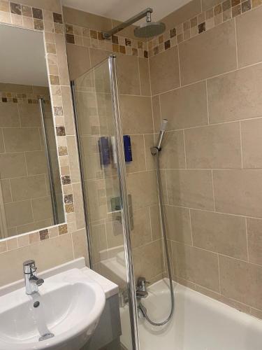 a bathroom with a shower and a sink and a toilet at Crowne Plaza East Midlands Airport by IHG in Derby
