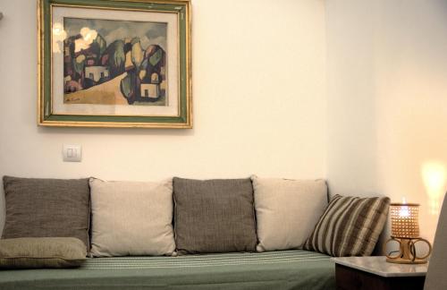a couch in a living room with a painting on the wall at Dimora dei Seclì in Galatina