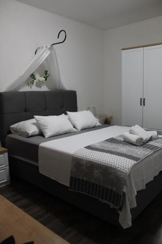 a bedroom with a large bed with pillows on it at Apartments Grmaca in Trogir