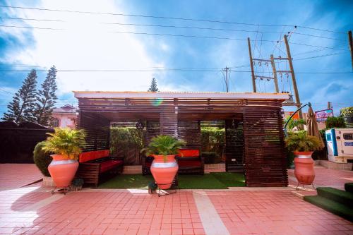 a small building with potted plants in front of it at Ibranad Apartments in Accra