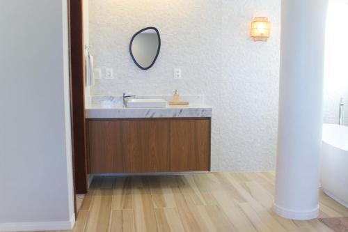 a bathroom with a sink and a mirror at Farol de Itapuã Praia Hotel in Salvador