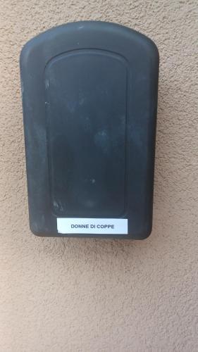 a black box on the wall with a sign on it at Donna di Coppe Apartment in Torre Boldone