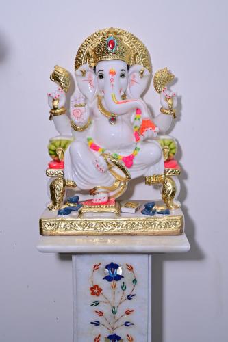 a statue of three nuns sitting on a shelf at Date Palm Hotel in Gurgaon