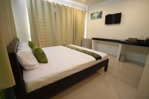 Ένα ή περισσότερα κρεβάτια σε δωμάτιο στο Phangan Guest House